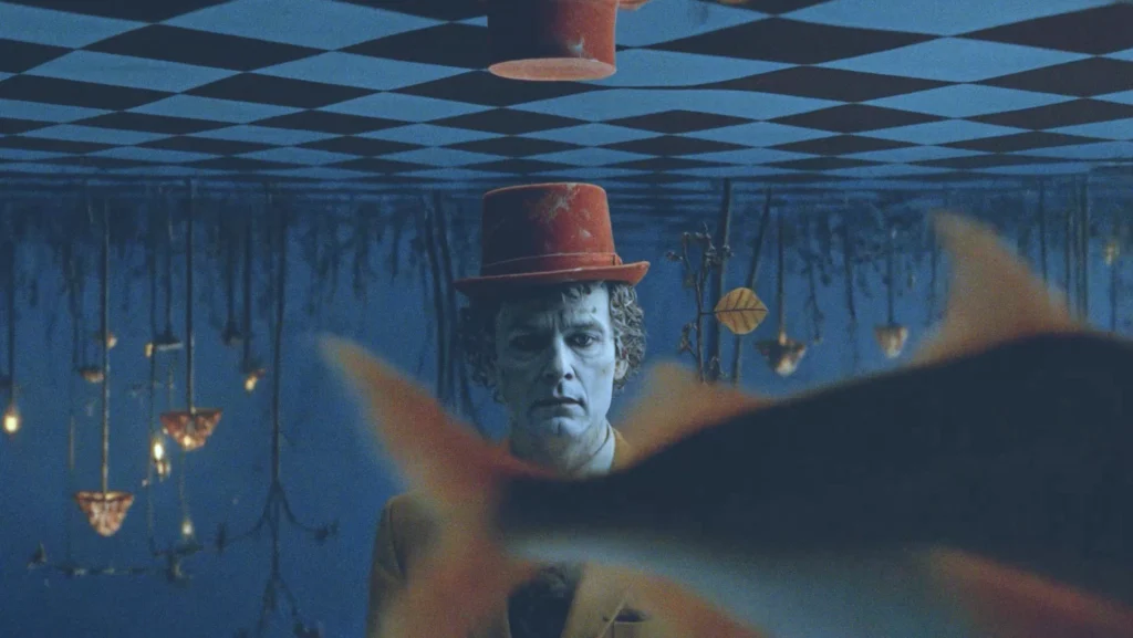 Tek Yol: LAB83 AI music video frame: a goldfish swims past the man’s face under water