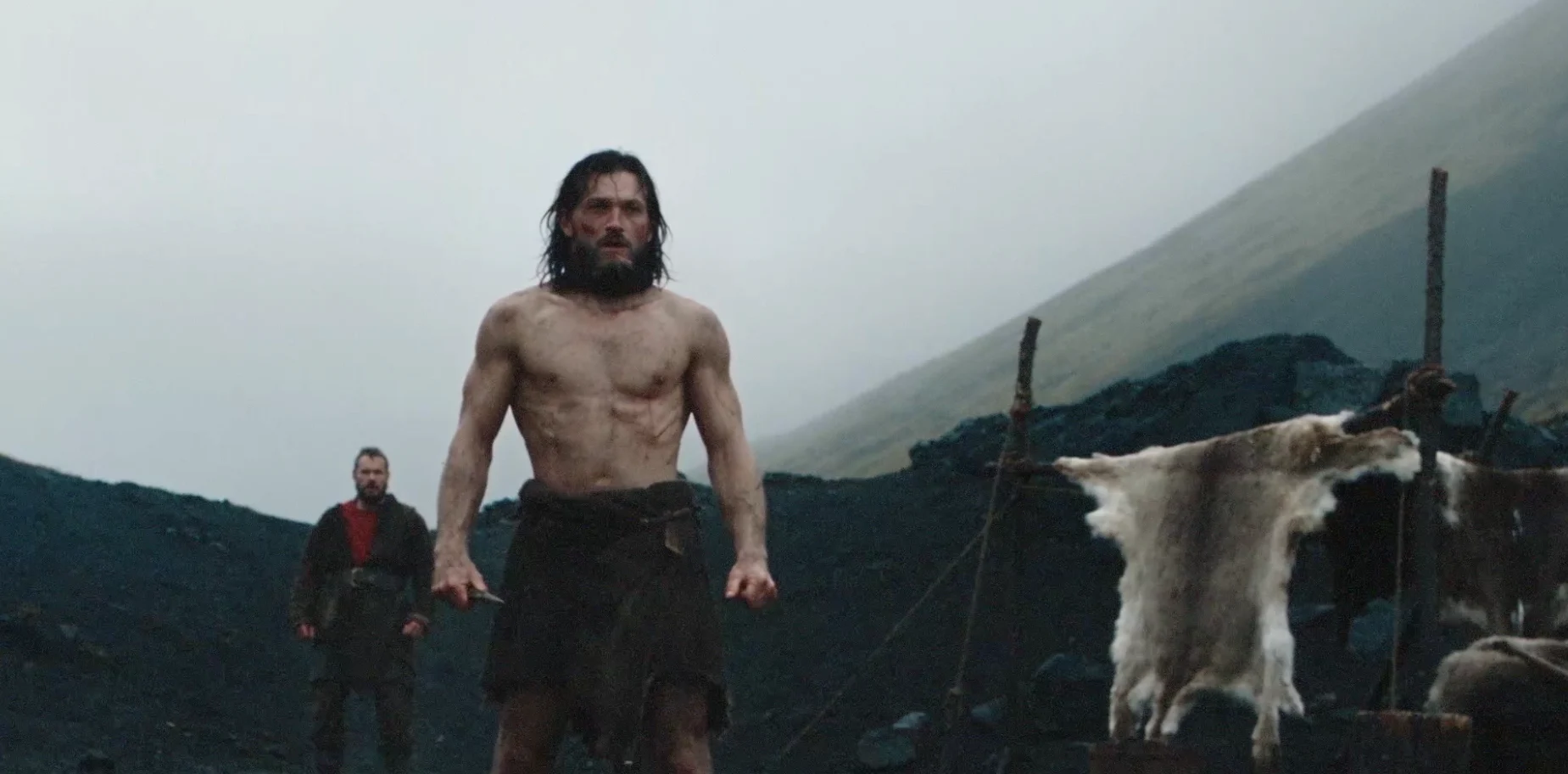 The warrior facing the camera inside the camp.