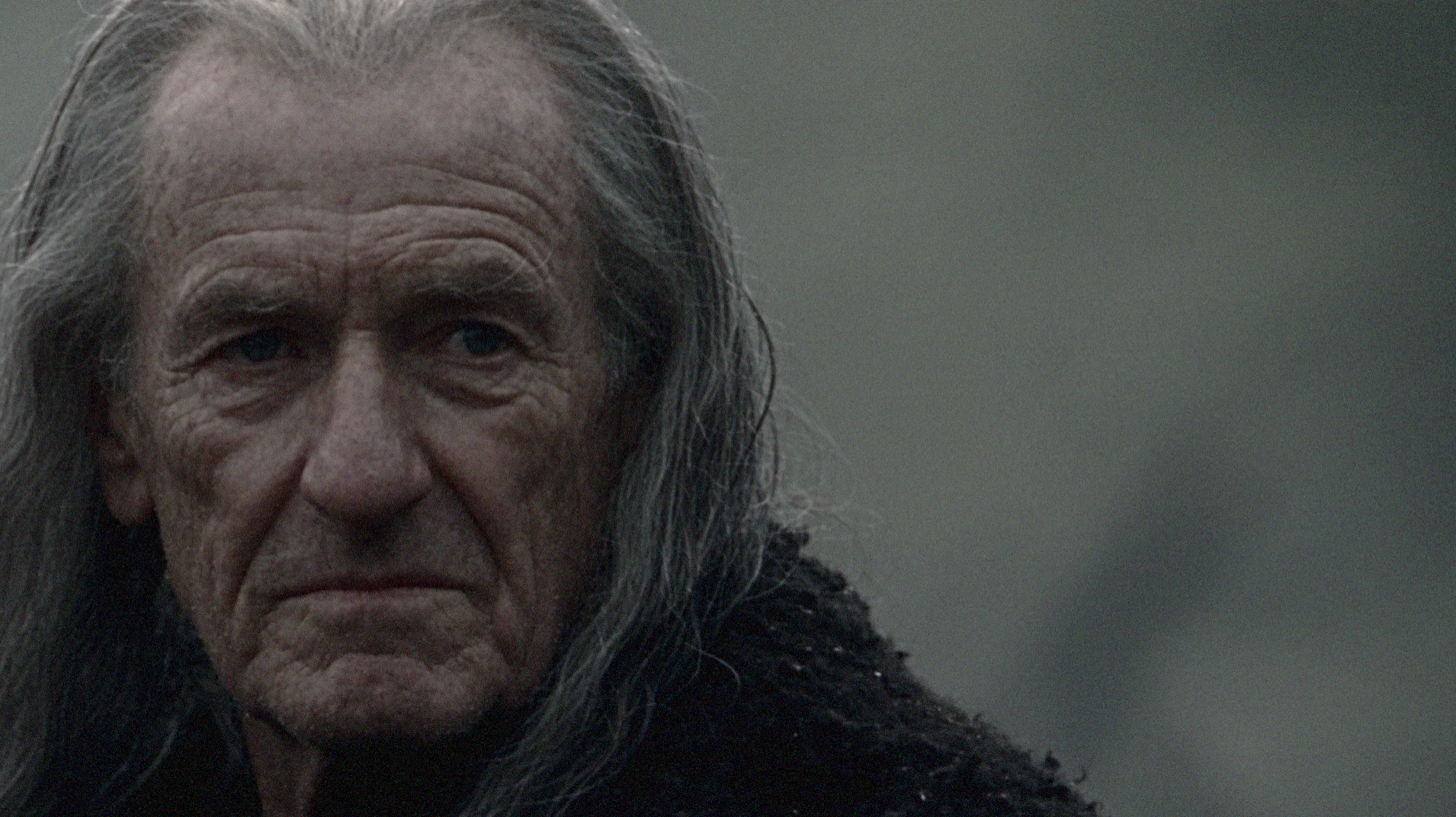 The old man — the narrator and silent witness who appears to understand THYMOS beyond what the other characters can see.