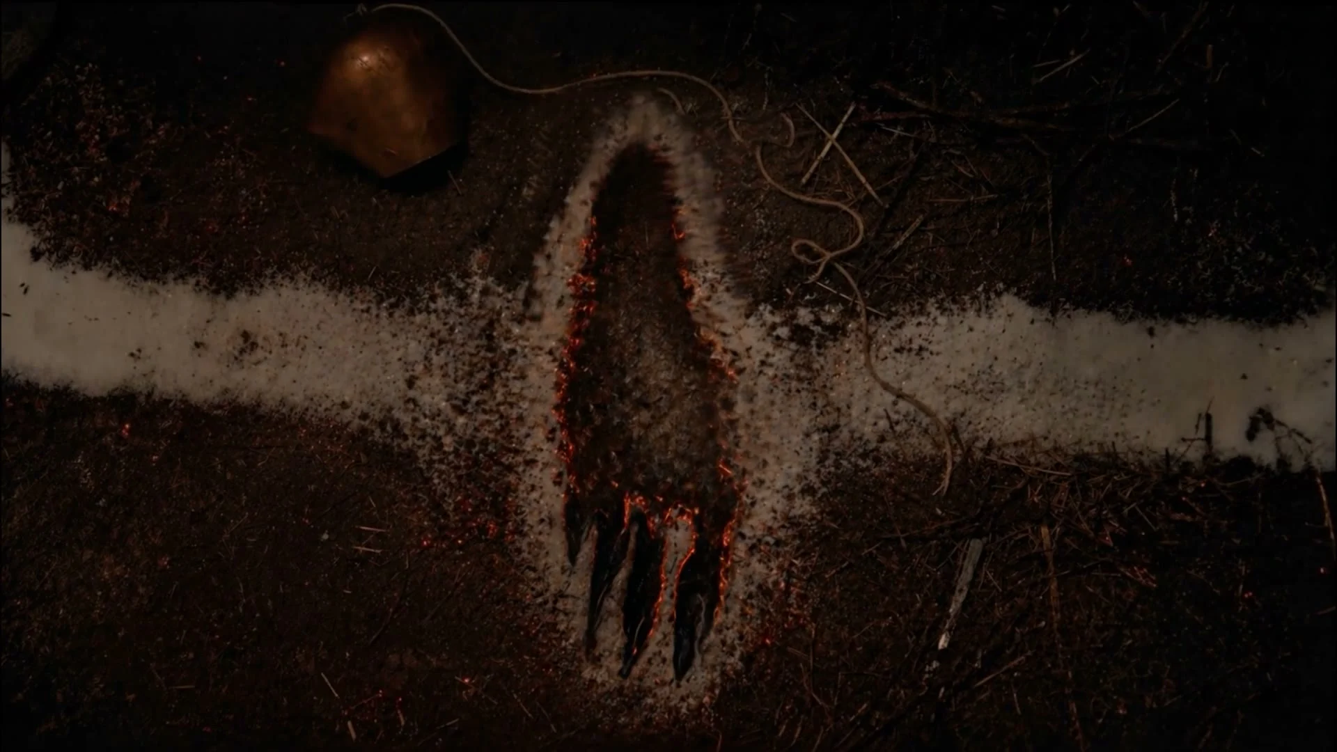 Blair Witch AI visual effects frame: a clawed footprint burned into the earth across a white line.