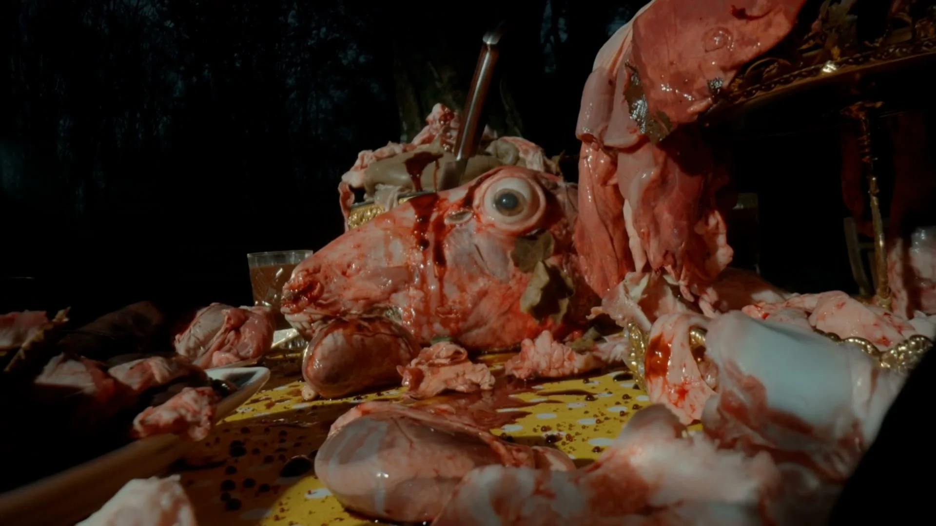Blair Witch AI visual effects frame: a skinned head with one staring eye on the feast table.