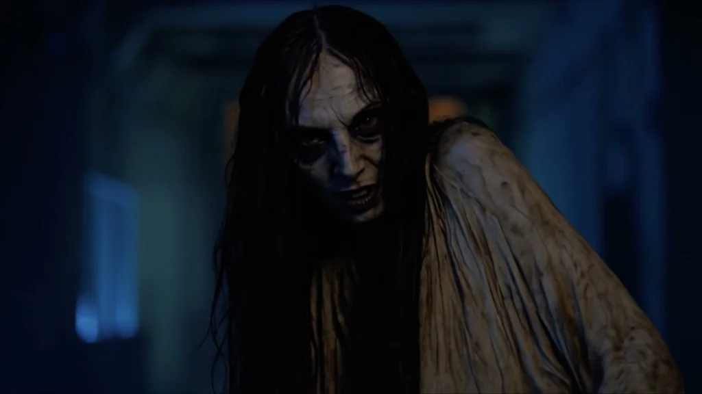Blair Witch AI visual effects frame: a long-haired figure leans toward the camera in a dark blue corridor.
